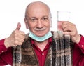 Smiling senior man taking a dietary supplement Royalty Free Stock Photo