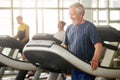 Smiling senior man on treadmill at gym. Royalty Free Stock Photo