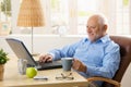 Smiling senior man using laptop Royalty Free Stock Photo