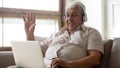 Smiling mature man in headphones have video call Royalty Free Stock Photo