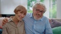 Smiling senior man and woman looking at camera. Husband hugging wife Royalty Free Stock Photo