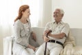 Smiling senior man having fun with happy daughter at home