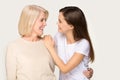 Smiling senior mother and grownup daughter hugging Royalty Free Stock Photo