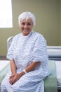 Smiling senior patient sitting on bed in hospital Royalty Free Stock Photo