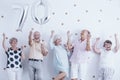 Smiling senior people celebrating with silver balloons