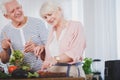 Smiling senior people preparing salad Royalty Free Stock Photo