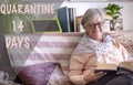 Smiling senior woman alone at home for quarantine in self isolation, attractive elderly people grey hair reading a book - concept Royalty Free Stock Photo