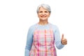 smiling senior woman in apron showing thumbs up Royalty Free Stock Photo