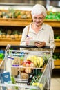 Smiling senior woman checking list Royalty Free Stock Photo