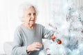 Senior woman decorating christmas tree Royalty Free Stock Photo