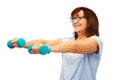 Smiling senior woman with dumbbells exercising Royalty Free Stock Photo