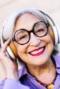 smiling senior woman enjoying listening to music Royalty Free Stock Photo