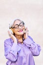smiling senior woman enjoying listening to music Royalty Free Stock Photo