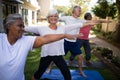 Smiling senior woman exercising with friends at park Royalty Free Stock Photo