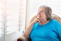 Smiling Senior Woman Gazing Out of Her Window