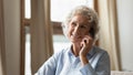 Smiling senior woman having cellphone talk at home Royalty Free Stock Photo