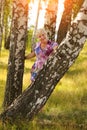 Smiling senior woman holding tree trunk in park Royalty Free Stock Photo