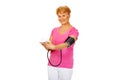 Smiling senior woman measuring blood pressure Royalty Free Stock Photo