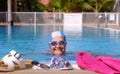 Smiling senior woman swimm into the swimming pool with swimming goggles and cap - active retiree enjoying healthy lifestyle