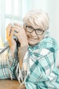 Smiling Senior Woman Thinking About Something And Holding A Cup Of Tea.