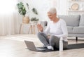 Smiling Senior Woman Training At Home Online Via Laptop, Waving At Camera Royalty Free Stock Photo