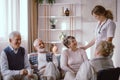 Seniors talking with nurse in the retirement home Royalty Free Stock Photo