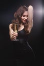 Smiling sensual woman with glass of champagne posing