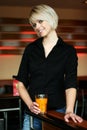 Smiling young woman drinking orange juice Royalty Free Stock Photo