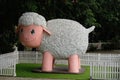 A smiling sheep statue at a zoo