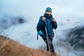 Smiling Sherpa men in sunglasses backpacker with trekking poles hiking and enjoying Mera peak climbing acclimatization walk on