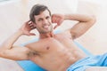 Smiling shirtless young man doing sit ups in fitness studio Royalty Free Stock Photo