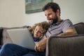 Father and son sitting at home watching a movie online Royalty Free Stock Photo