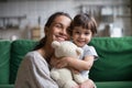 Smiling single young mum embracing little daughter Royalty Free Stock Photo