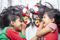 Smiling sisters decorating their hair with Christmas decorations