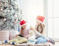 Smiling sisters taking opened gifts