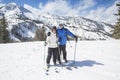 Smiling skiers skiing together on a beautiful Mountain top on a sunny day