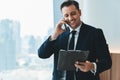 Smiling skilled businessman talking phone while looking at data. Ornamented. Royalty Free Stock Photo