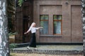 smiling slender woman with long blond hair walks along the city street Royalty Free Stock Photo