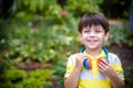 Smiling small boy 4-7 year old posing outdoors. Looking at camera with headphones on his neck. Little kid listening music enjoy Royalty Free Stock Photo