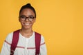 Smiling smart adolescent afro american lady pupil in glasses with backpack looking at camera ready to study