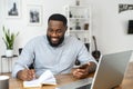Smiling smart african american freelancer making notes Royalty Free Stock Photo