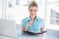 Smiling smart businesswoman holding datebook