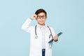 Smiling smart doctor boy with white medical coat and stethoscope