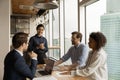 Happy indian team leader holding negotiations meeting with diverse colleagues. Royalty Free Stock Photo