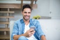 Smiling smart man using smartphone