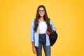 Smiling smart pretty teen student lady with backpack, in glasses study, enjoy learn at school