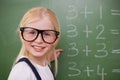 Smiling smart schoolgirl pointing at something