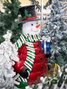 Smiling snowman with gift box and top hat