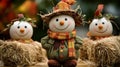 Smiling Snowmen and Scarecrow Figurines on Hay Bales Royalty Free Stock Photo