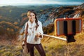 Smiling solo traveller woman taking selfie using selfie stick